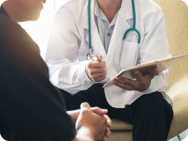 Doctor and patient sitting and reviewing a clipboard chart